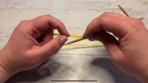 Index finger and thumb preparing to open yarn. 