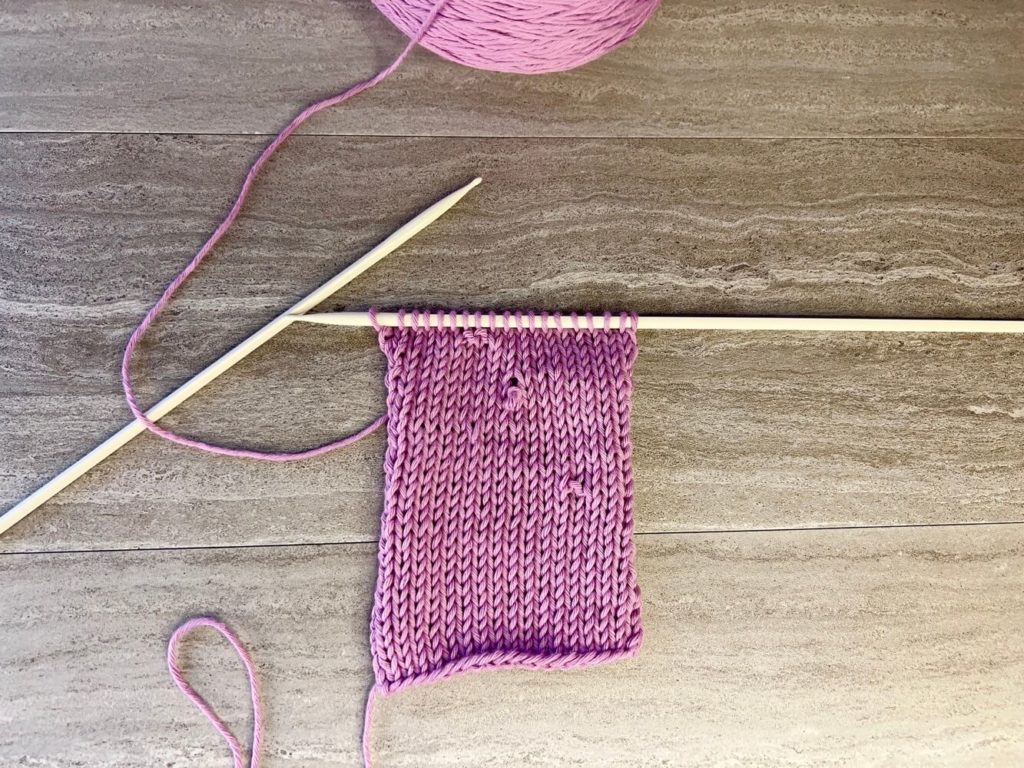 A knit swatch with several mistakes that need to be fixed. 