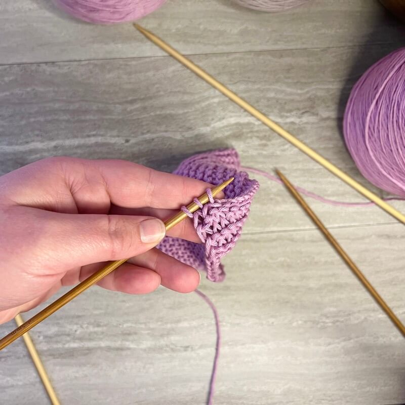 add an i-cord hanging loop Slip the three stitches to Double Pointed Needles (DPN)